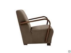 Side view of the Dallas armchair highlighting the generous one-piece seat with armrests and Canaletto walnut wood feet