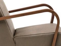 Detail of the thin curved armrests in solid Canaletto walnut wood