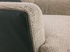 Detail of the armrest of the Doyle armchair in the two-tone version, with leather back and fabric inner seat joined by a grosgrain stitching in a customisable colour