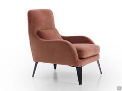 Three-quarter view of the Mabel armchair where the prominent black painted metal feet can be seen