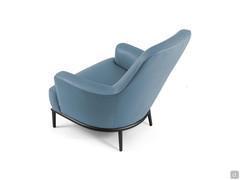 Detail of the visible stitching and metal base that outline the refined, curved contours of the René armchair