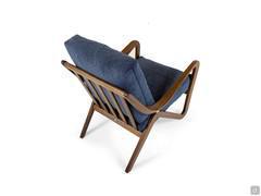 Detail of the high-quality and elegant curved solid wood frame on the armrests and slatted frame on the backrest