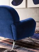 Detail of shaped armrest and chrome-plated metal spike feet, available in several colours