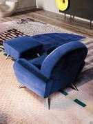 Lune armchair with matching footstool, both upholstered in velvet and featuring the same high toed foot