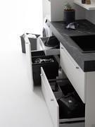 Details of the basket base units of the Oasis L03 laundry composition. The pull-out door is equipped with a laundry basket and practical internal drawer