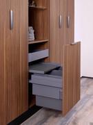 Pull-out door positioned under the open compartment, equipped with drawer, tray and removable double laundry basket