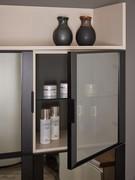 Cabinet wall units with matt black aluminium frame with integrated handle. Internal glass shelf
