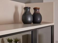 The display cabinets are enclosed at the top and bottom by two open compartments