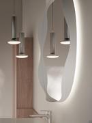 Detail side view showing the wavy profile of the matt white lacquered metal frame