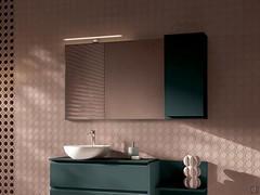 Composition with washbasin base unit, wall unit, open element and Aura mirror completely in matt lacquer. Tau 60 applied spotlight