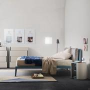 Oscar bed with thin bed-frame and high feet, headboard with upholstered cushions