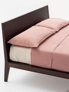 Particular silhouette of the headboard that tapering slightly in the central part joins the bed frame