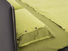 Detail of the padded headboard and the contrasting piping