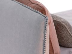 Detail of fabric headboard cover finished with horse stitching (closed embroidery)