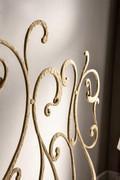 Detail of hand-forged wrought iron headboard finished in gold leaf (finish not available)