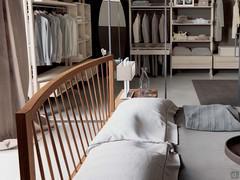 Detail of the curved headboard with tilted slats, in natural walnut wood