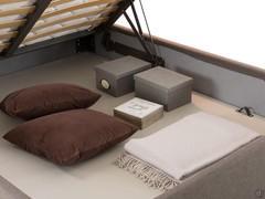 Detail of the large and roomy openable storage compartment under the bed
