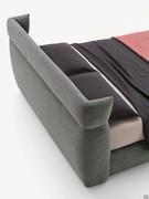 Detail of the wraparound headboard of the bed Destin, fully upholstered on the back as well