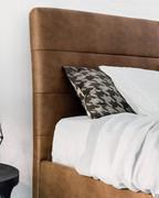 Detail of the headboard decorated with horizontal stitching