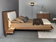 Side view of the double bed Nelson by Bonaldo in Canaletto walnut essence