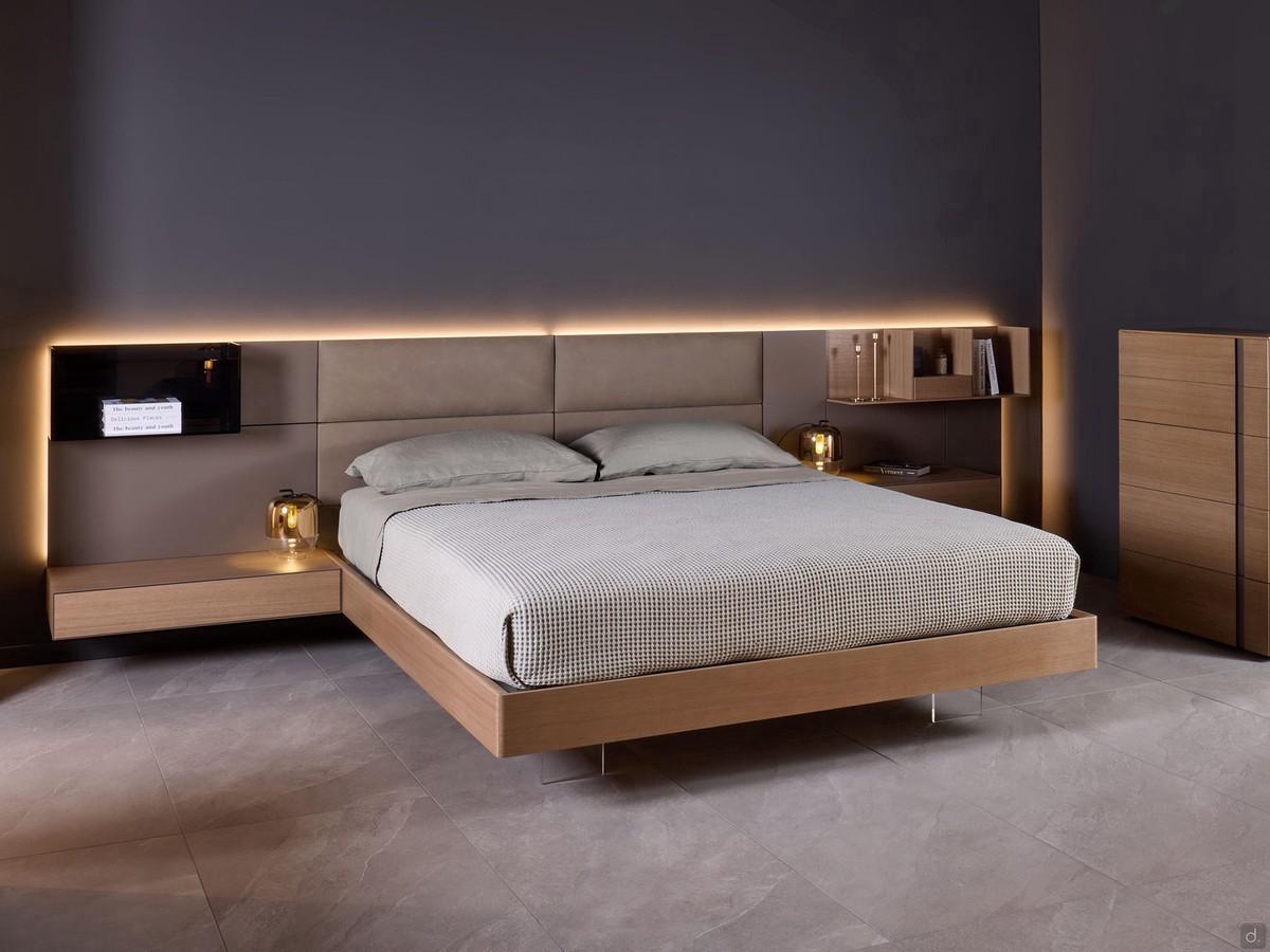 Wooden bed with California boiserie, here proposed in the version with upholstered headboard and matt lacquered side boiserie. Bed frame and bedside tables in Havana oak