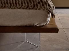 Detail of the methacrylate feet to give the Ghibli bed its characteristic suspended effect. The bed frame is upholstered in tobacco-coloured Tivano leather.