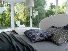 Detail of the enveloping headboard of the round, economical Globe bed