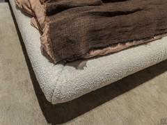 Detail of the fabric-covered bed frame, removable and washable, on the Pascal bed