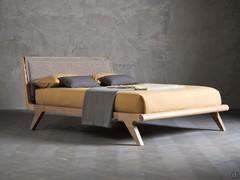 Sebastian bed in the version with upholstered headboard and wooden feet