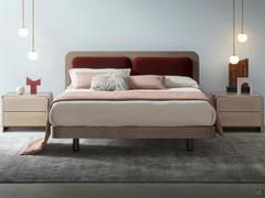 The front view shows the curved corners of the bed frame and headboard, which offer the viewer a feeling of 'softness' emphasised by the large headboard cushions