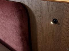 Detail of the swivelling reading spotlight, optionally available on both sides of the large headboard