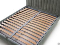 Detail of the wooden slatted base that completes the sleeping surface of the Joao bed
