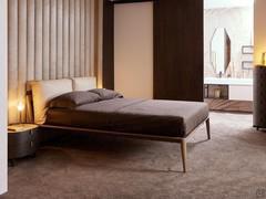 Aries bed in solid mink-stained ash with headboard and cushions upholstered in beige leatherette, shown here in standard double size