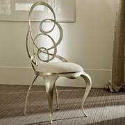 Ghirigori chair with sabre-shaped legs and metal swirls seat-back