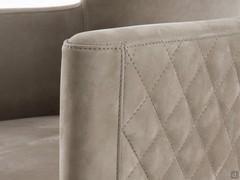 Details of the armrest and tub-shaped backrest of the elegant chair Evora