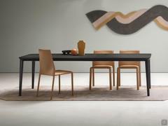 Chairs Corinne all upholstered in natural leather, matching the Redmoon dining table in oak veneer fashion wood