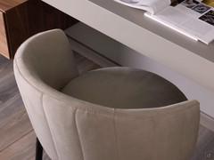Details of the curved tub-shaped backrest of the elegant chair Leslie