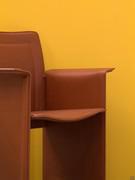 Detail of the slightly contoured seat set between the two sides of the chair that serve as armrests