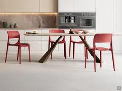 Sprint polypropylene dining chair in coral red (RAL 2012) finish, matching the Shore table