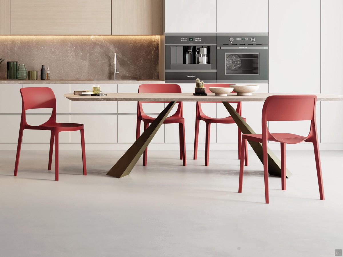 Sprint polypropylene dining chair in coral red (RAL 2012) finish, matching the Shore table