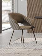 Niva armchair, with curved, outward-opening backrest reminiscent of two barely-there armrests