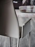 Detail of the smooth backrest and slightly curved armrest, distinctive features of Cattelan's Norma chair