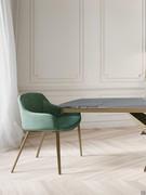 Side view of the Count armchair with bronze painted metal legs
