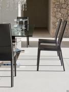 Margot chairs by Cattelan upholstered in leather around a dining table