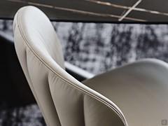 The quilted pattern on the backrest is reminiscent of a seashell