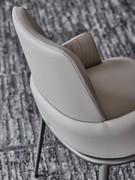 Detail of the backrest of the Belinda chair, here in the version with low, wrap-around armrests, entirely upholstered in leather