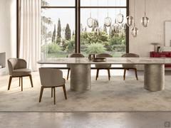 Piper chairs entirely upholstered in leather and offered with a revolving, self-centring wooden trestle base