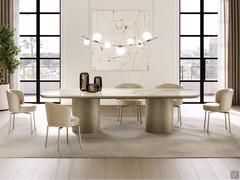 Piper chairs shown here with single-colour light leather upholstery, tone in tone with the 4 titanium-coated metal legs