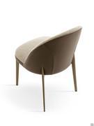 Detail of the tubular metal legs that graft directly onto the backrest, slimming the figure