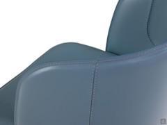 Detail of the riveted seams of the real leather upholstery, deliberately left visible and becoming a decorative motif